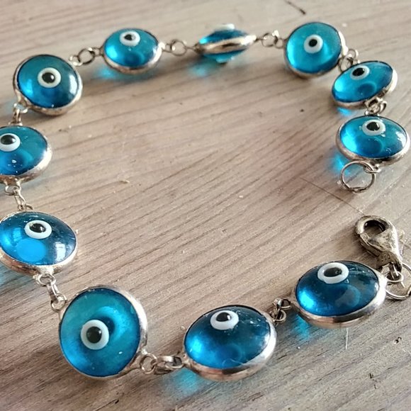Bracelet, 11 semi-transparent blue pieces with black and white eye-like parts - Picture 2 of 3